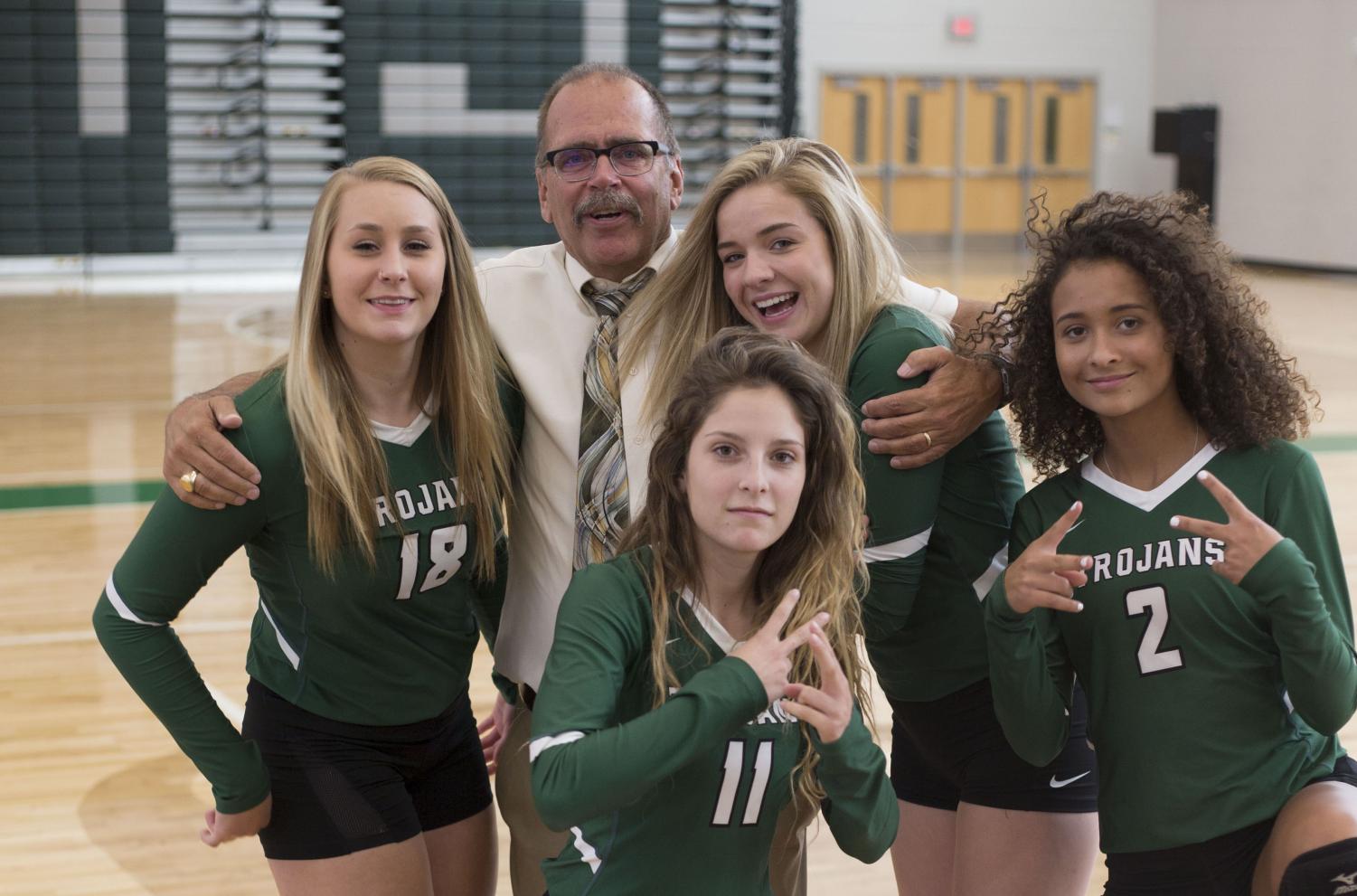 Principal Brad Diller pals around with seniors Maddie Dedic, Hallie Jimenez, Jill Phipps and Jaliegah Davis during their team photo day. Diller has announced that the 2017-2018 school year will be his last as he is retiring.