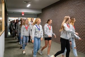 Both the Trojan girls and boys tennis teams participate in the march of champions after each team won team titles at the state tournament in Gillette.