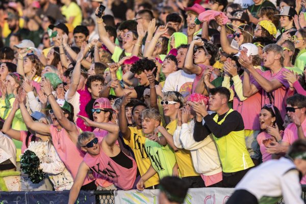 Kelly Walsh Trojans cheer on the Trojan football team at the annual Oil Bowl on October 11, 2024.  The theme for the game was neon colors.  